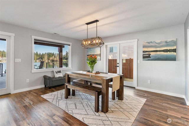 dining room featuring hardwood / wood-style flooring and a chandelier