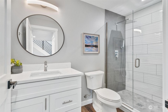 bathroom with vanity, toilet, and a shower with shower door