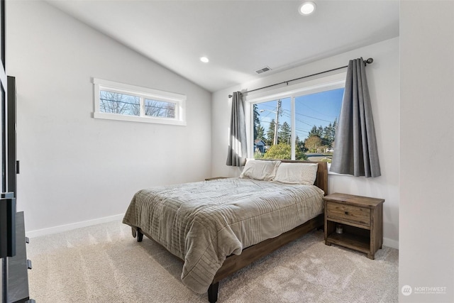 carpeted bedroom with vaulted ceiling and multiple windows