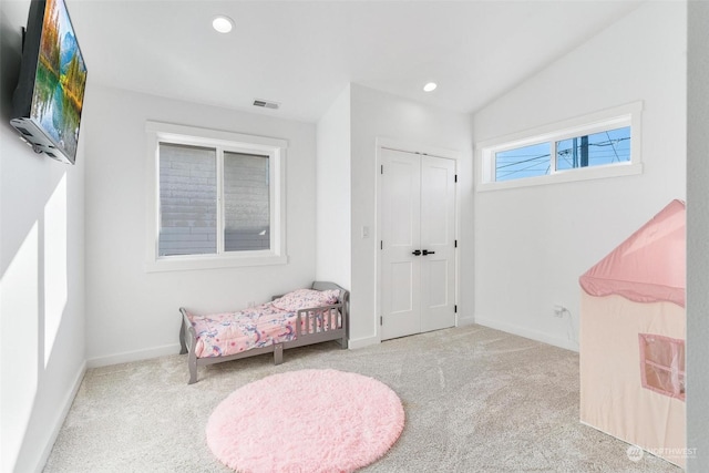 sitting room with vaulted ceiling and light colored carpet