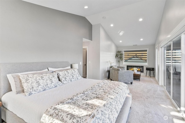 carpeted bedroom with high vaulted ceiling