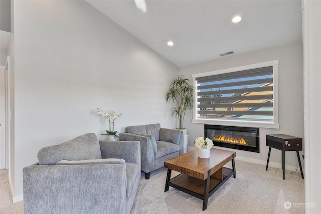 carpeted living room featuring vaulted ceiling