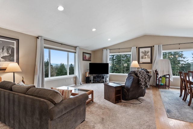 living room with vaulted ceiling and light hardwood / wood-style flooring