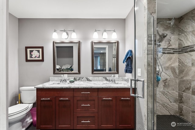 bathroom featuring vanity, toilet, and an enclosed shower