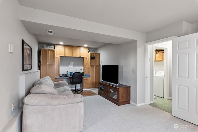 living room featuring washer / clothes dryer and light colored carpet