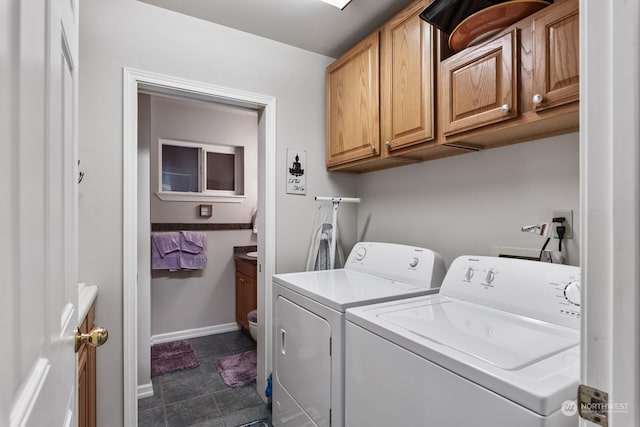 laundry room featuring cabinets and independent washer and dryer