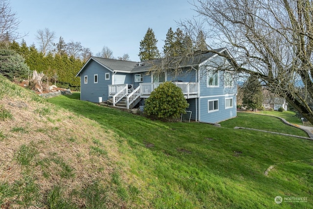 back of property featuring a deck and a lawn