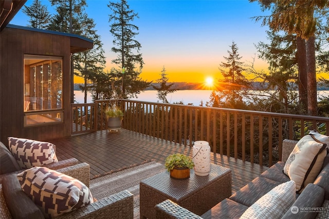 deck at dusk featuring an outdoor living space