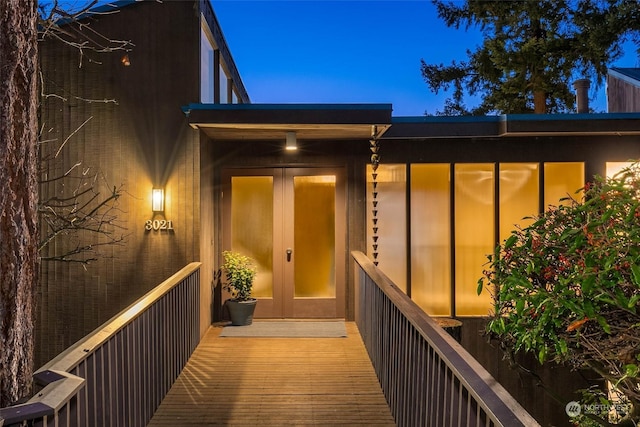 exterior entry at dusk featuring french doors