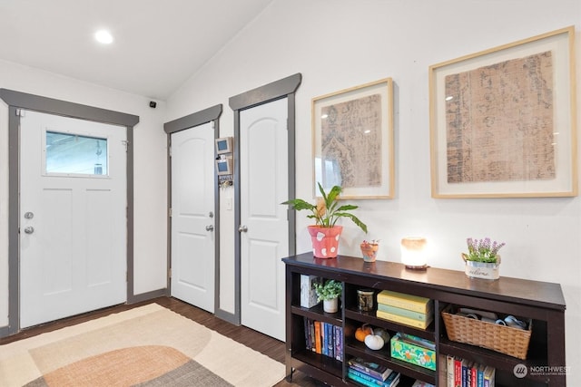 foyer featuring vaulted ceiling and dark hardwood / wood-style floors