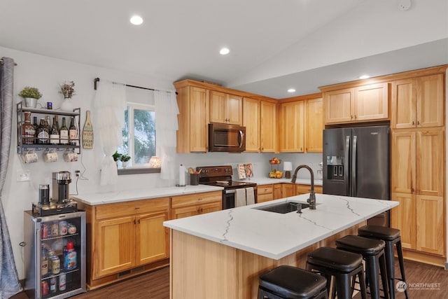 kitchen featuring beverage cooler, appliances with stainless steel finishes, sink, dark hardwood / wood-style floors, and a center island with sink