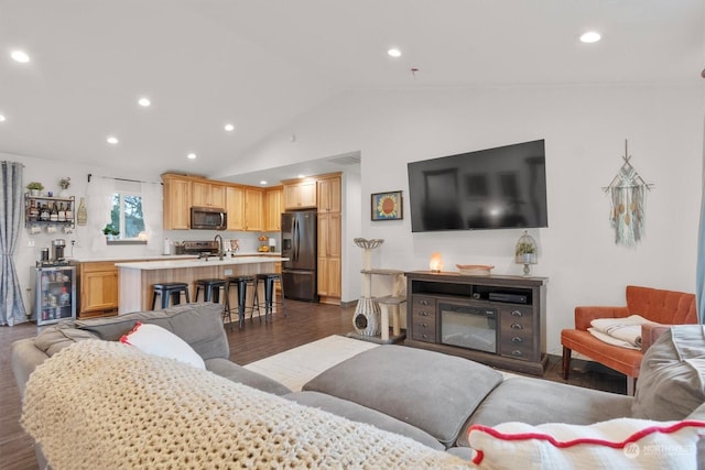 living room with lofted ceiling, sink, dark wood-type flooring, and beverage cooler