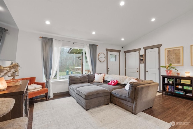 living room featuring lofted ceiling and light wood-type flooring