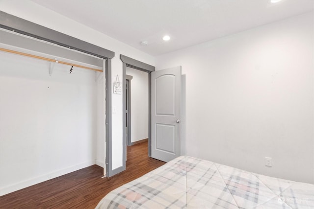 bedroom featuring dark wood-type flooring and a closet