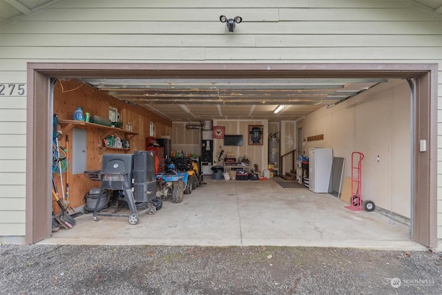 garage with electric panel and gas water heater