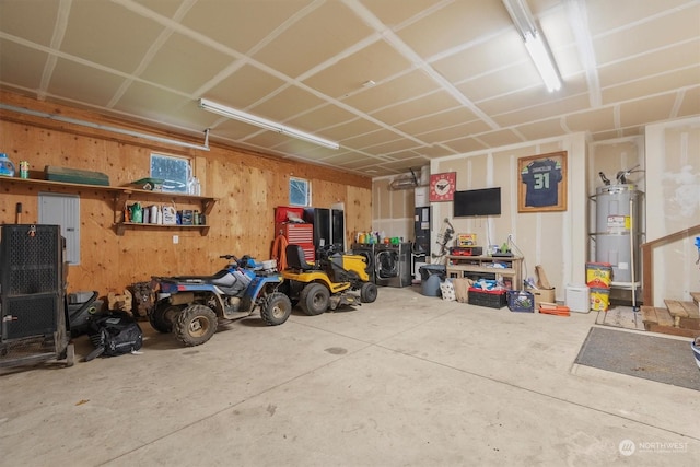 garage featuring wooden walls and strapped water heater