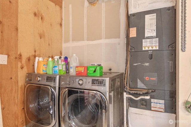 clothes washing area featuring separate washer and dryer and heating unit