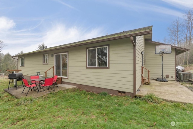 rear view of house featuring central AC unit, a patio area, and a yard