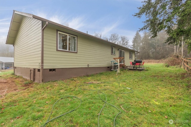 view of side of home with a lawn