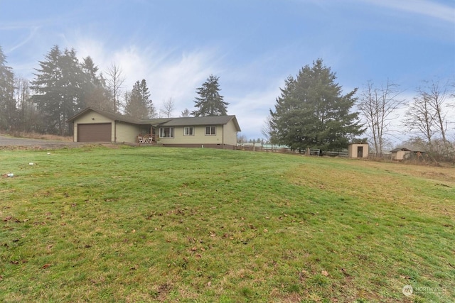 view of yard with a garage and a storage shed