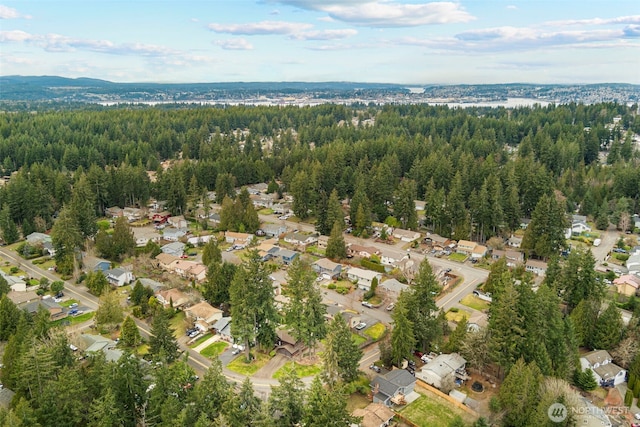 drone / aerial view featuring a residential view and a view of trees