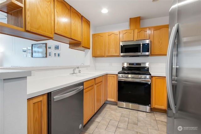 kitchen featuring light tile patterned floors, appliances with stainless steel finishes, and sink