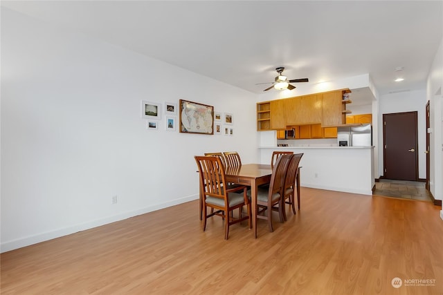 dining area featuring light hardwood / wood-style floors and ceiling fan