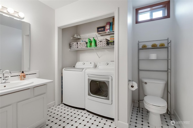 bathroom with toilet, vanity, and washer and clothes dryer