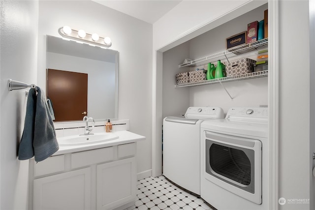 clothes washing area featuring washer and dryer and sink