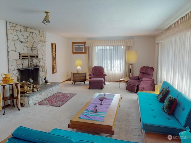 living room with a wall unit AC, carpet flooring, and a fireplace