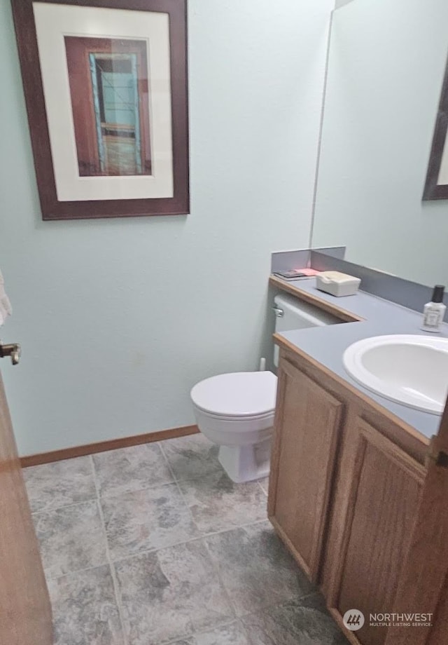 bathroom featuring toilet and vanity