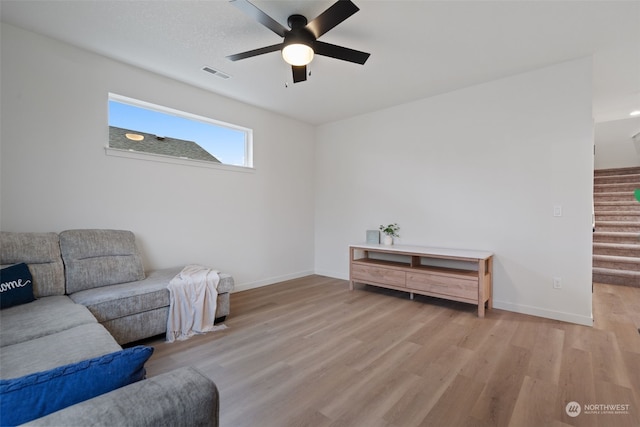 living room featuring ceiling fan and light wood-type flooring