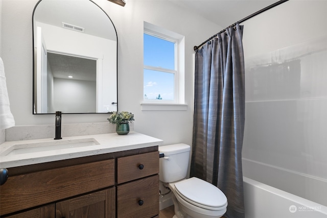 full bathroom featuring toilet, shower / bath combination with curtain, and vanity