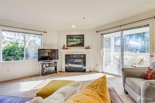 26291 Pennsylvania Ave NE Unit 106, Kingston, WA 98346 - carpeted living area featuring baseboards, a tile fireplace, a healthy amount of sunlight, and recessed lighting