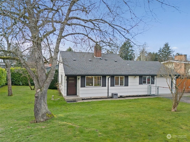 rear view of house with a yard