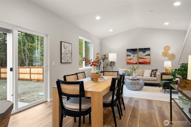 dining room with recessed lighting, vaulted ceiling, and wood finished floors