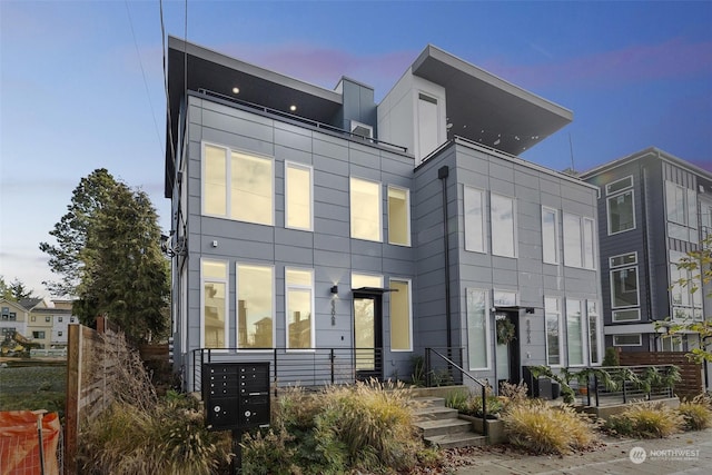 view of back house at dusk