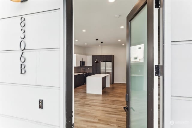 kitchen with stainless steel refrigerator and light wood-type flooring