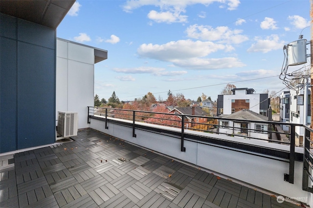 view of patio featuring cooling unit and a balcony