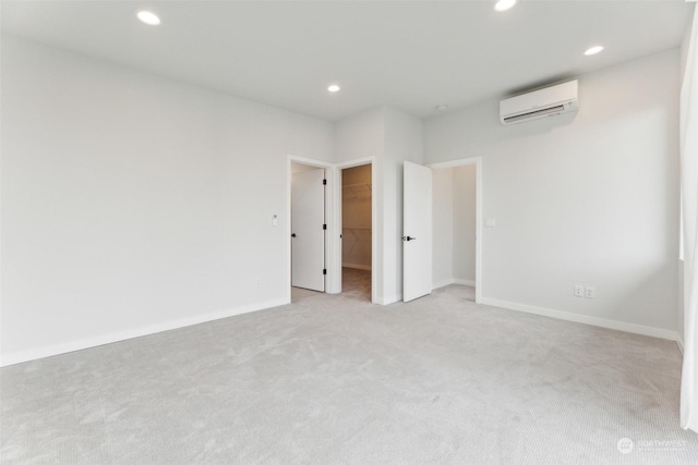 empty room with light carpet and a wall unit AC