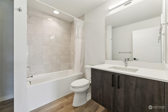 full bathroom with wood-type flooring, toilet, vanity, and shower / tub combo with curtain