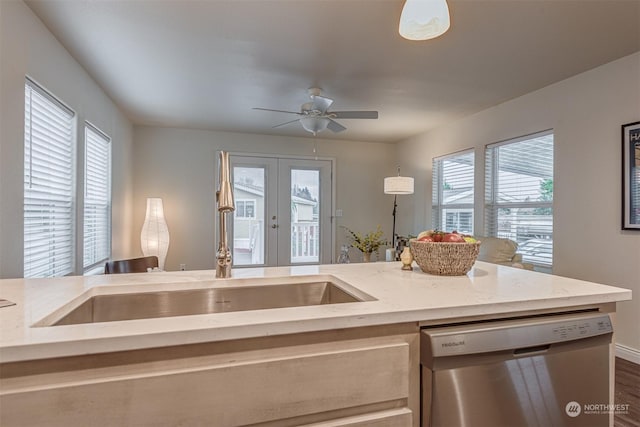 kitchen with french doors, stainless steel dishwasher, plenty of natural light, and decorative light fixtures