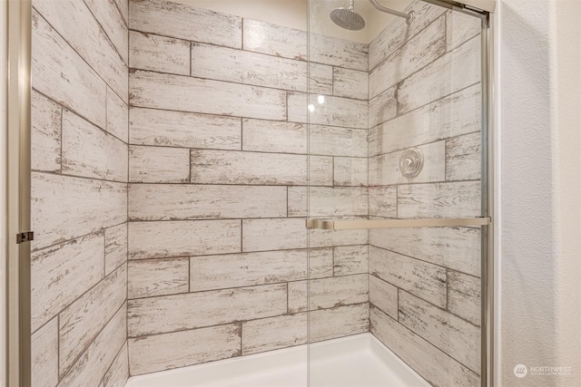 bathroom with tiled shower