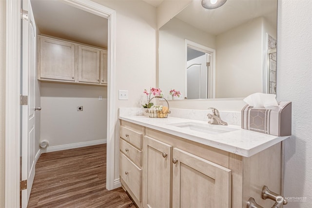 bathroom featuring hardwood / wood-style flooring and vanity