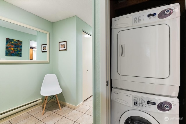 laundry room with light tile patterned floors, baseboard heating, and stacked washer / drying machine