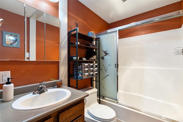 full bathroom featuring combined bath / shower with glass door, vanity, and toilet