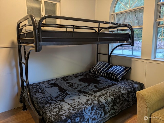 bedroom featuring hardwood / wood-style floors and multiple windows