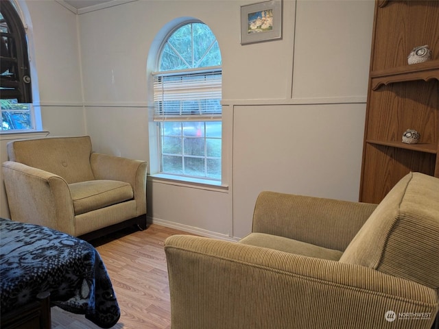 bedroom with light hardwood / wood-style floors and crown molding