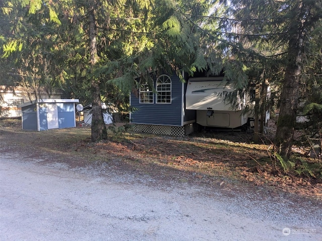 view of front of home with a garage and an outdoor structure