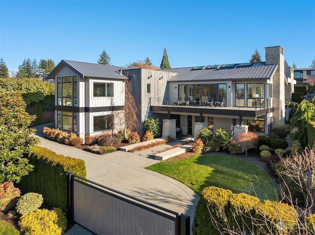 exterior space with a lawn and a balcony